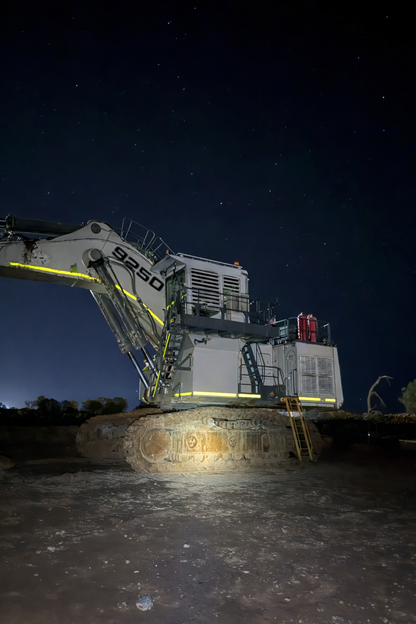 Full power mode headlamp illuminating mining excavator at night